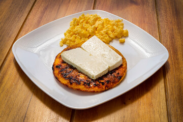 Traditional Colombian breakfast - Arepa chocolo with cheese and egg