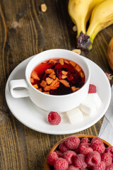 Red hot tea with raspberries, close up