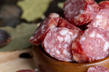 Dried veal sausage during slicing