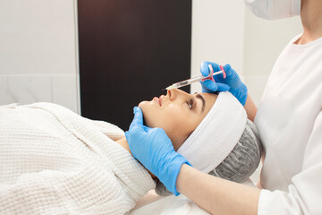 lip augmentation procedure using botox in cosmetology clinic, cosmetologist doctor in gloves makes...