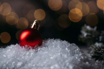 red christmas ball on snow