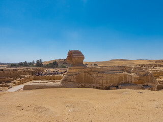 The largest and most famous sphinx is the Great Sphinx of Giza, situated on the Giza Plateau adjacent to the Great Pyramids of Giza on the west bank of the Nile River and facing east