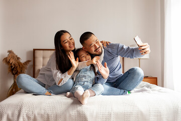happy asian family with smartphone chatting at home via video link online and greeting - Powered by Adobe