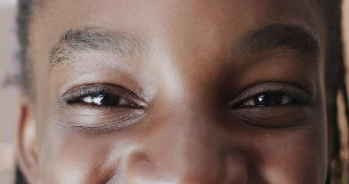 Close up portrait of eyes happy african american teenage girl looking at camera in slow motion