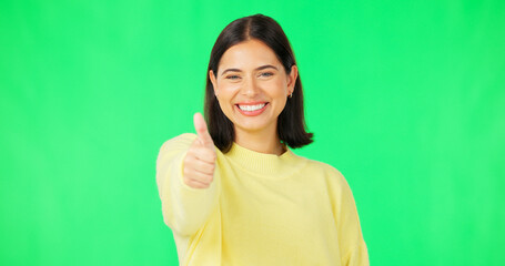 Fototapeta premium Happy woman, thumbs up and green screen for winning, success or agreement against a studio background. Portrait of female face with smile showing thumb emoji, yes sign or like on chromakey mockup
