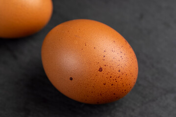 A whole orange chicken egg close-up on the table