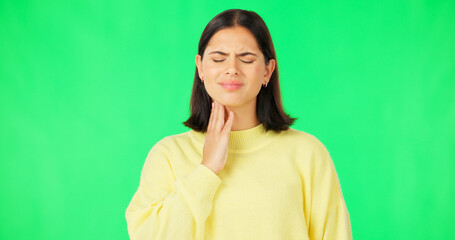 Fototapeta premium Green screen, woman and pain in throat, flu infection and suffering from cold virus in studio. Sick female model, allergies and massage neck for health risk, covid and itchy voice of thyroid problem