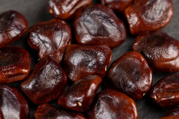 brown tamarind seeds on the table, scattered seeds