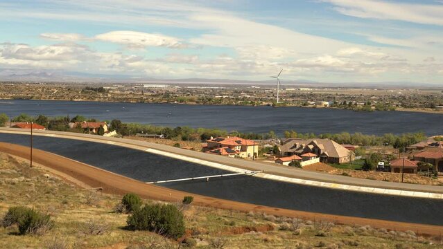 The famous California Aqueduct near Palmdale California. This waterway supplies water to Los Angeles from central California. The lake in the background is a private reserve.