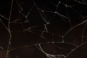glass broken into a large number of pieces and cracks