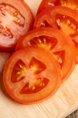 Sliced red fresh tomatoes on a board
