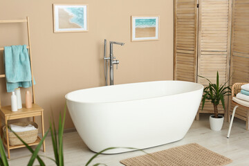 Fototapeta na wymiar Stylish bathroom interior with white beautiful tub