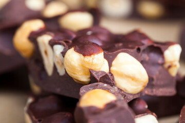 Pieces of homemade milk chocolate with lots of hazelnuts