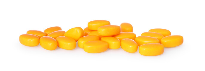 Tasty orange dragee candies on white background