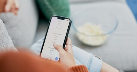 Woman, hands and phone on gym website for fitness, online sign up or membership on living room sofa at home. Hand of female searching or browsing homepage of gymnasium on smartphone app for exercise