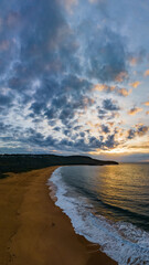 Sunrise seascape with clouds and gentle surf