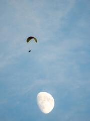 paragliding in the sky with moon