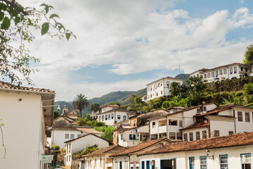 Fototapeta na wymiar Ouro Preto, Minas Gerais, Brazil – April, 7, 2023. Typical baroque architecture of the historic city of Ouro Preto. Pilar Church and Rosario Church area.