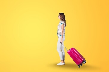 Happy young woman traveler with a suitcase