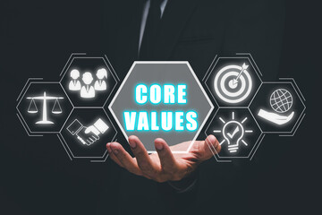 Core values, corporate values concept, Businessman hand holding core values icon on virtual screen.