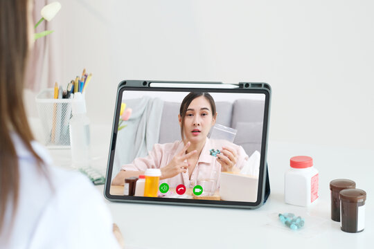 Asian woman patient make video call counseling doctor about healthcare by digital tablet, Telemedicine, Pharmacist