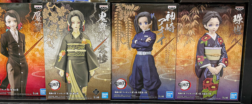 Various female action figures from Demon Slayer maga series for sale at a comic store.