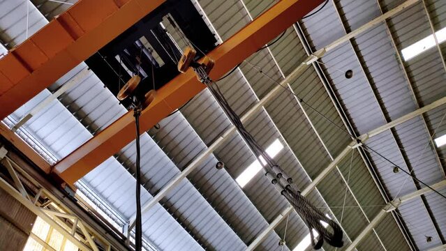 Yellow overhead crane in a factory. Large crane at a factory. Shot from below - Industrial video concept