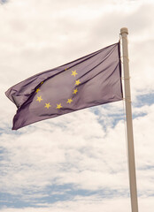 EU Flag waving in the wind against cloudy sky. Fluttering European Union flag.