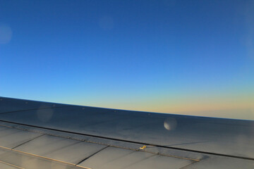 Fototapeta premium sky from the plane, plane wing, sunset time