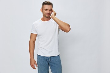 Man headache, migraine, high fever, in white T-shirt on white isolated background, copy space