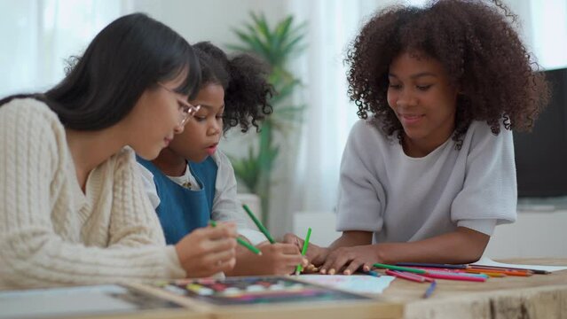 Little girl enjoy drawing and painting with her sister.
