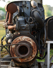 Fototapeta na wymiar Close-up image of a rusty old engine that appears to be damaged in need of repair.