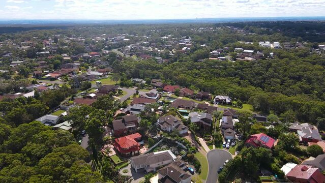 Aerial drone pullback reverse view of Barden Ridge in the Sutherland Shire, Sydney NSW showing Woronora River on a sunny day  
