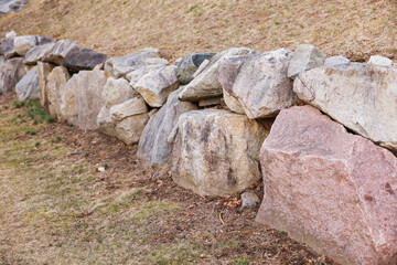 close-up shot of rocks with various textures, colors, and patterns. Rocks symbolize strength,...