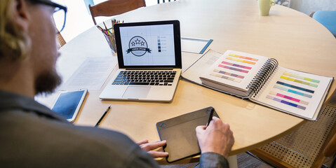 Close up creative freelancer man hand working of graphic design pencil project. On hand of graphic designer working with interactive pen display, digital Drawing tablet and Pen on a computer.