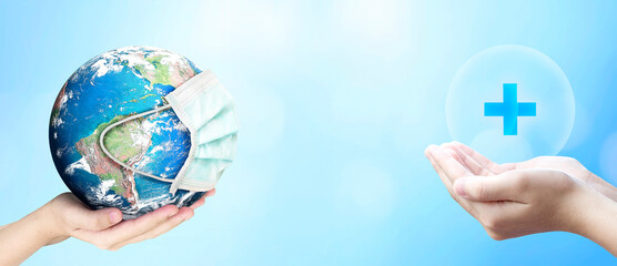 Earth Day concept,  Earth wearing a mask abd virtual plus medical network connection icons on blurred blue nature background. Elements of this image furnished by NASA 