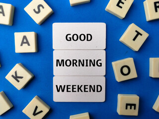 Toys word and wooden board with the word GOOD MORNING WEEKEND