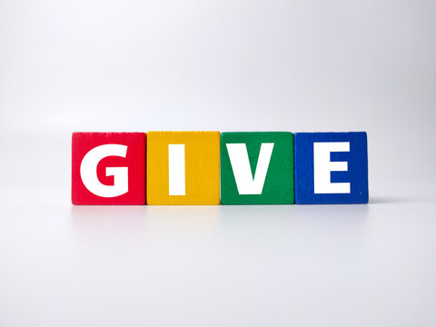 Colored wooden cube with the word GIVE