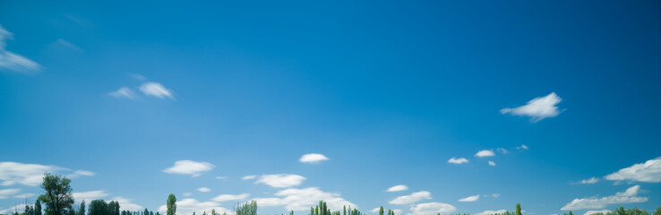Long exposure photo of white clouds in blue sky