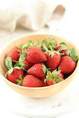 Fresh Strawberries in Wooden Bowl on White Table