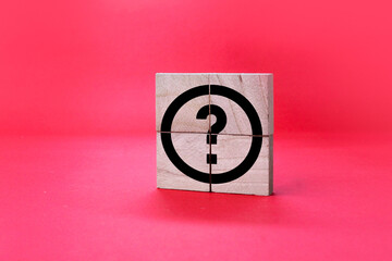 Fototapeta na wymiar wooden square with question mark icon. the concept of questions or Q and A. Faq concept. Define problems to find solution. 
