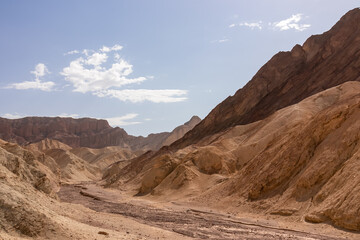 Golden Canyon trailhead with scenic view of colorful geology of multi hued Amargosa Chaos rock formations, Death Valley National Park, Furnace Creek, California, USA. Barren Artist Palette landscape