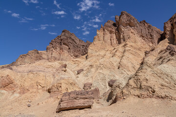 Fototapeta na wymiar Golden Canyon trailhead with scenic view of colorful geology of multi hued Amargosa Chaos rock formations, Death Valley National Park, Furnace Creek, California, USA. Barren Artist Palette landscape