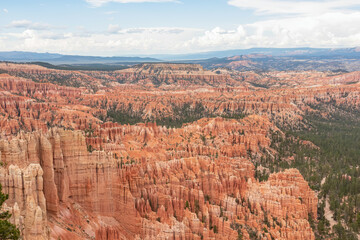 Fototapeta na wymiar Panoramic aerial view of massive hoodoo sandstone rock formations in Bryce Canyon National Park, Utah, USA. Natural unique amphitheatre sculpted from the reddest rock of the Claron Formation. Awe