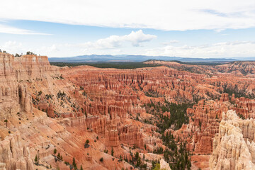 Fototapeta na wymiar Panoramic aerial view of massive hoodoo sandstone rock formations in Bryce Canyon National Park, Utah, USA. Natural unique amphitheatre sculpted from the reddest rock of the Claron Formation. Awe