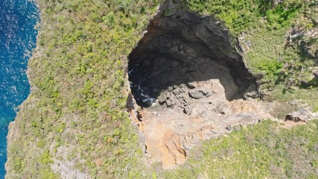 Aerial top down shot Showing birds flying over Cave at Cabo Cabron National park in Summer