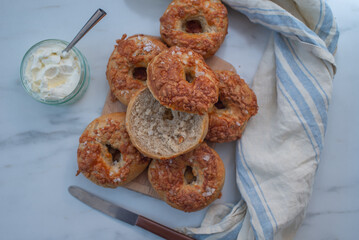 home made whople grain Bagels with cheese on a table