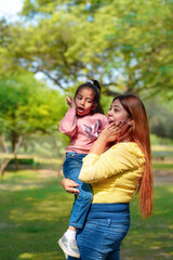 Fototapeta premium Indian woman with her little daughter at park