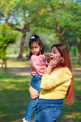 Indian woman with her little daughter at park