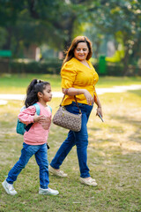 Indian woman with her little daughter at park